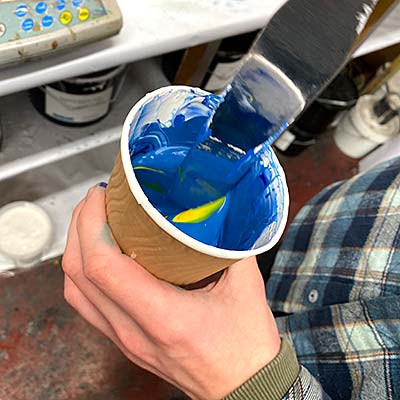 Mixing ink in cup with spatula