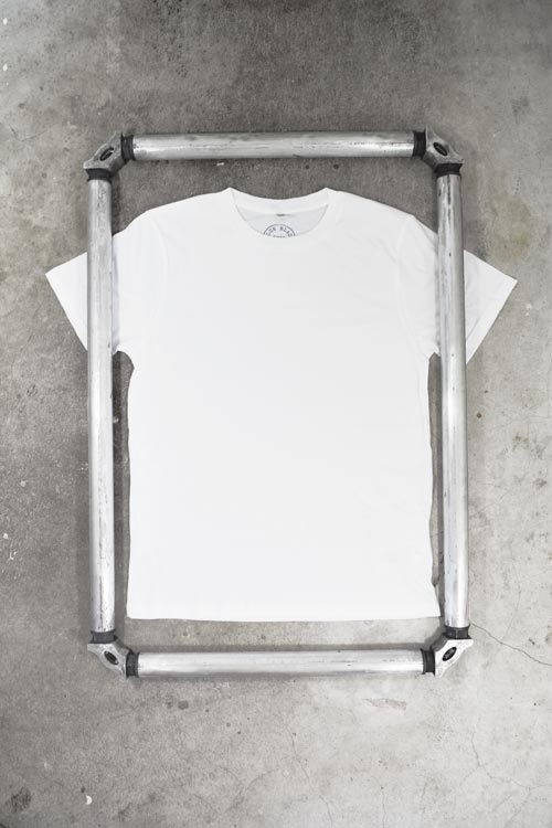 Photo of screen printing frame overlaying t shirt to represent print area